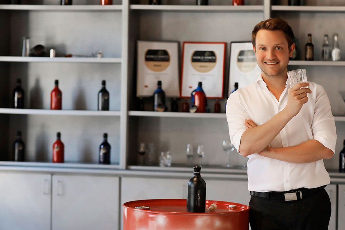 A man standing in front of several types of Gin