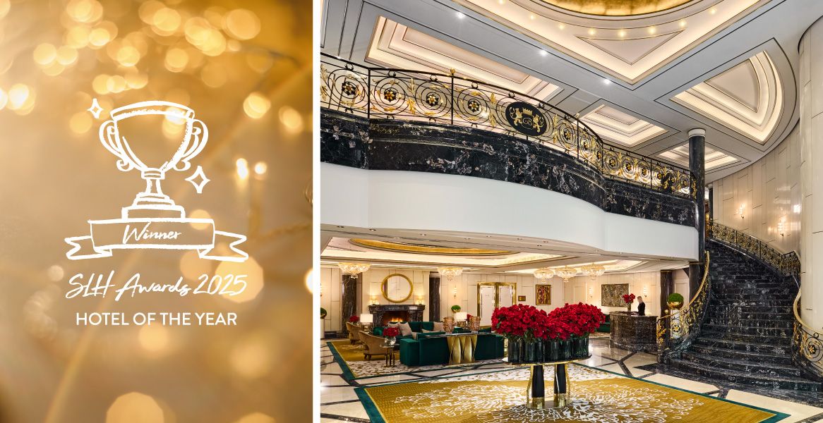 Elegant lobby of Breidenbacher Hof Düsseldorf with sweeping staircase and reference to the “SLH Awards 2025 – Hotel of the Year” award.