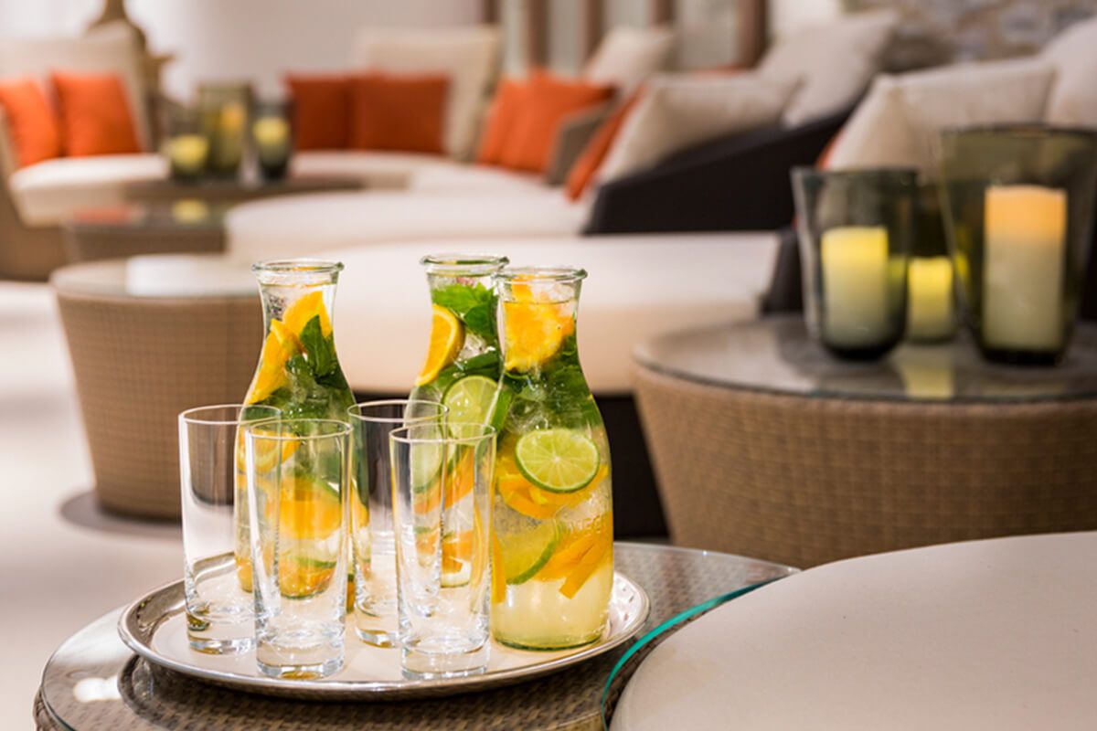 Water with lime, orange and mint on the side table of the relaxation loungers in the wellnesshotel in Düsseldorf