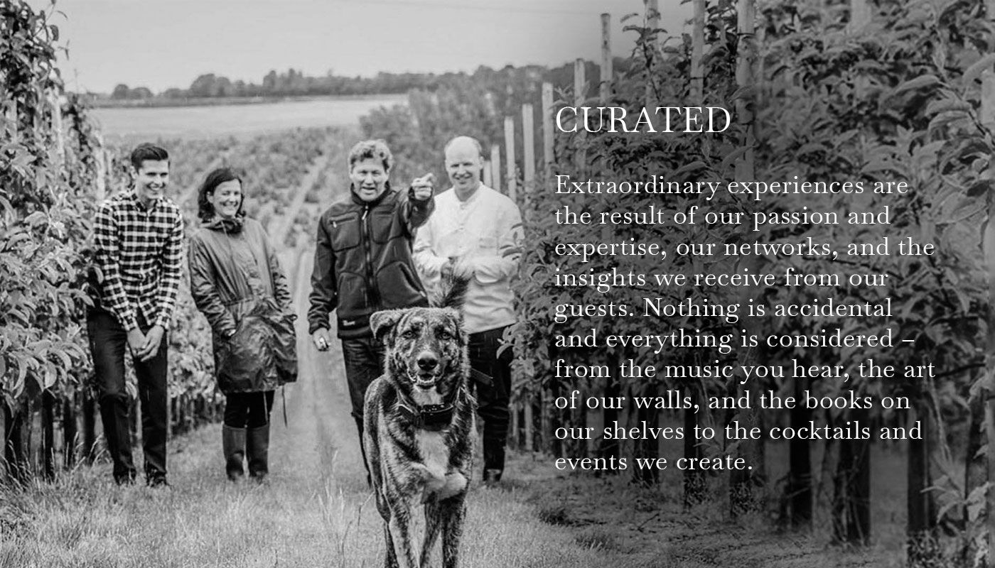 A black and white photo of some people and a dog on a farm with a text on the topic "Curated"